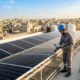 Technician inspecting solar panels 202608251319
